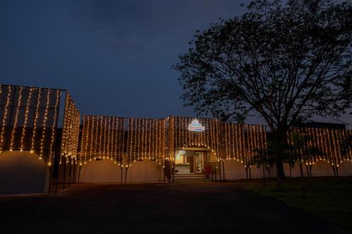 a building covered in christmas lights at night at Shine Residency in Mysore