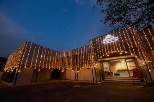 a building covered in christmas lights at night at Shine Residency in Mysore