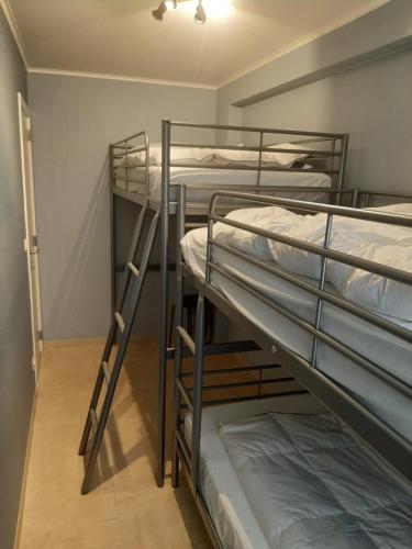 a room with three bunk beds in it at House Kimberly 194, bus 102 in Nieuwpoort