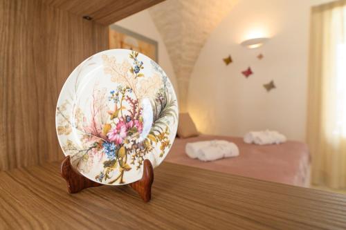a plate sitting on a table in a room at LUXURY ROOM CASSESE in Ceglie Messapica