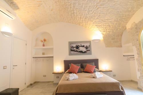 a bedroom with a bed with a stone ceiling at LUXURY ROOM CASSESE in Ceglie Messapica