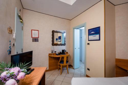 a living room with a couch and a table at Hotel Centrale in Bologna