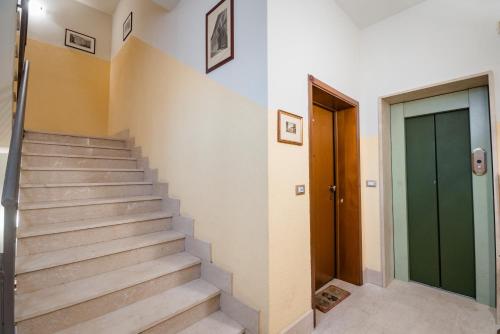 a staircase in a house with a green door at Hotel Centrale in Bologna