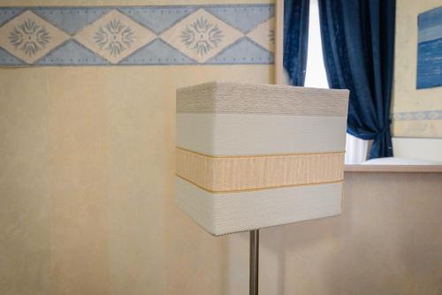 a lamp with three cardboard boxes on top of it at Hotel Centrale in Bologna