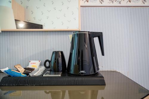 a coffee maker sitting on top of a counter at Hotel Centrale in Bologna