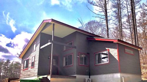 a house with a cross on the side of it at 八ヶ岳ヴィラ・M9 in Hokuto