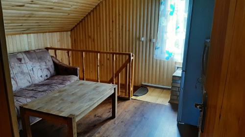 a room with a couch and a table in it at Sodyba pas Juozą in Milkai