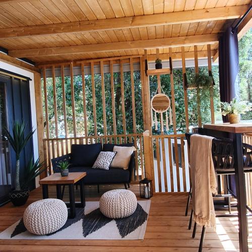 a screened in porch with a couch and a table at Mobile home Sunflower - Selce in Selce