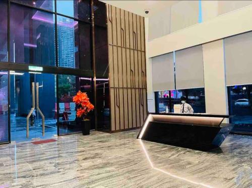 a lobby with a bench in the middle of a building at Sky pool 4 star hotel grade stay in i-City in Shah Alam