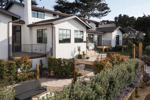a white house with a garden in front of it at Villa Mara Carmel in Carmel