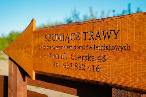 a wooden sign with the wordsurance travels on it at Szumiące Trawy - Bory Tucholskie in Tleń