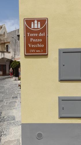 a sign on the side of a building at Mezza Torre B&B in Procida