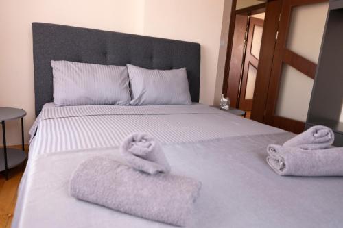 a bedroom with a bed with towels on it at Guesthouse Gaby in Sapareva Banya