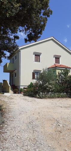 a large white building with two windows on it at Kelk Loznati in Loznati