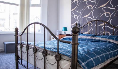 a bedroom with a bed with a blue comforter at 33 Turner street in Redcar