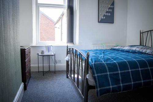 a bedroom with a bed and a window and a table at 33 Turner street in Redcar