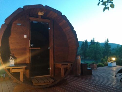 a wooden barrel sitting on top of a deck at Apartamenty Równia 2 in Ustrzyki Dolne