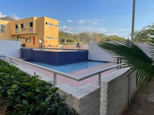 a swimming pool in front of a building at ApartaLujo Tu Estancia de Ensueño in Santa Marta