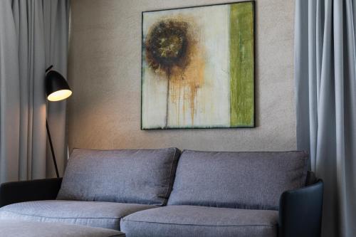 a living room with a couch and a painting on the wall at Marchegg Apartments in Naturno