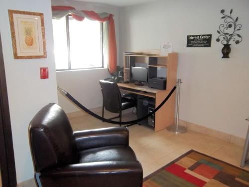 a room with a desk with a computer and a chair at Americas Best Value Inn New Paltz in New Paltz