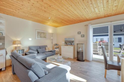 a living room with two couches and a table at La Mer in Altefähr