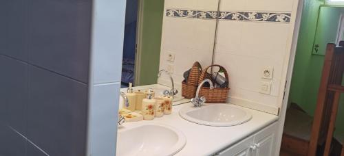 a bathroom with two sinks and a mirror at Breakfast at Lella's in Nice