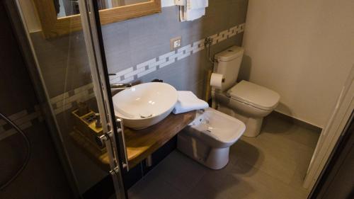 a bathroom with a sink and a toilet at 111 apartments & rooms in Patti