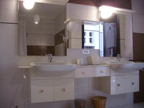 a bathroom with two sinks and a mirror at Maria del Mar in Monopoli