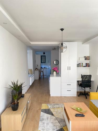 a living room with a couch and a table at Modern Studio Apartment in the Old Town in Sarajevo