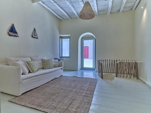 a living room with a white couch and a rug at Flair Naousa in Naousa