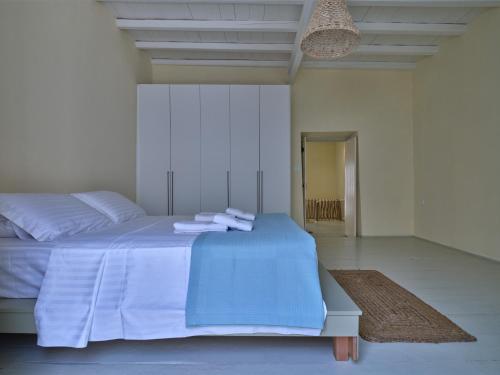 a bedroom with a bed with towels on it at Flair Naousa in Naousa