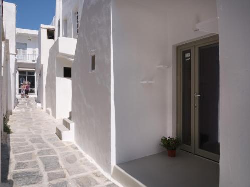 a hallway of a white building with a door at Flair Naousa in Naousa
