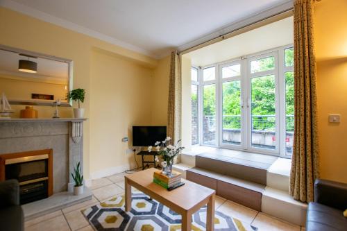 a living room with a fireplace and a window at 125 - The Duplex at Gort Na Coiribe, by Shortstays in Galway