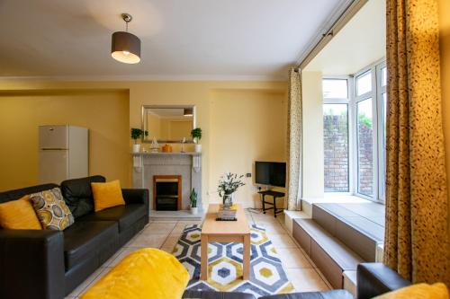 a living room with a couch and a fireplace at 125 - The Duplex at Gort Na Coiribe, by Shortstays in Galway