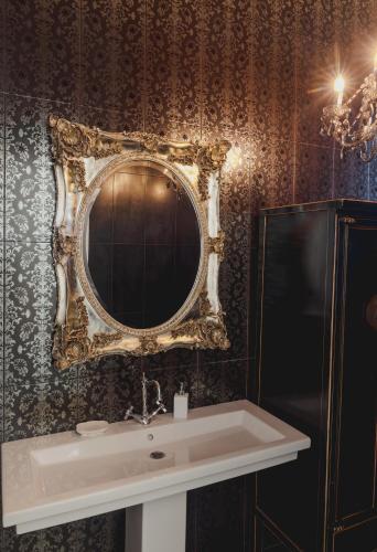a bathroom with a sink and a mirror on the wall at Sia's Luxury Maisonette in Pikérmion