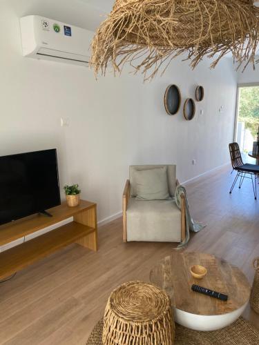 a living room with a tv and a couch at KSQUARED in Protaras