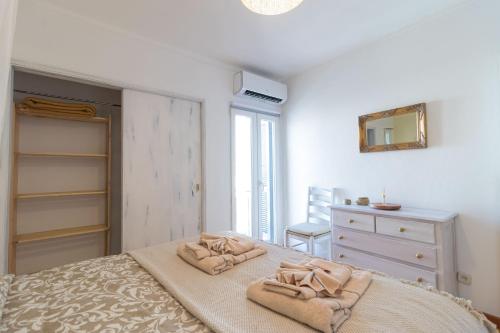 a bedroom with a bed and a dresser and a mirror at Downtown & Beach in Albufeira