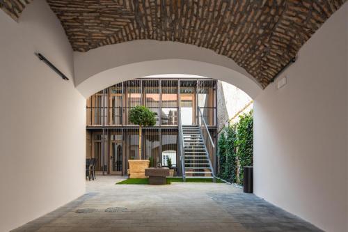 an archway leading into a building with a staircase at r12 Apartments in Győr