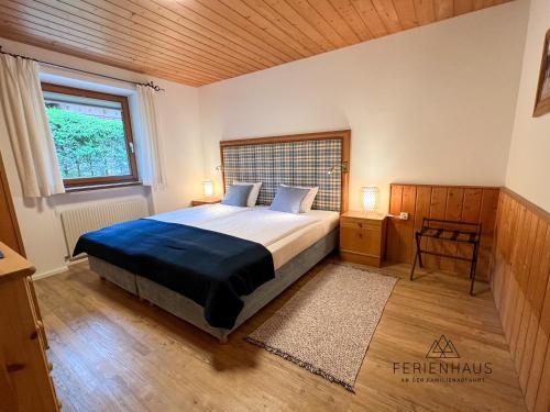 a bedroom with a bed and a window at Gartenwohnung an der Familienabfahrt in Brixen im Thale