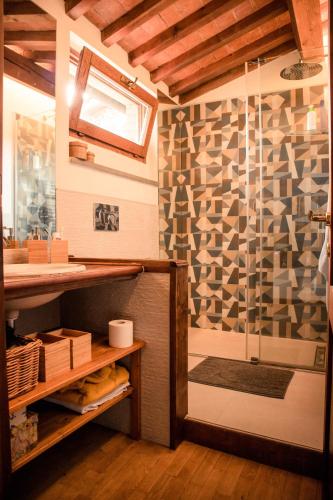 a bathroom with a shower with a glass door at Social Garden - Private Room in Calci