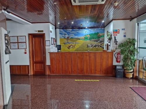 a lobby with a large mural on the wall at Hotel Trindade Coelho in Mogadouro
