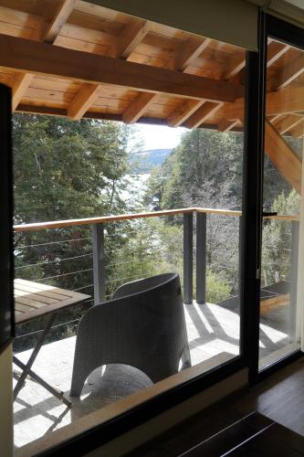 a chair sitting on a balcony with a view at Amarras in Villa Pehuenia