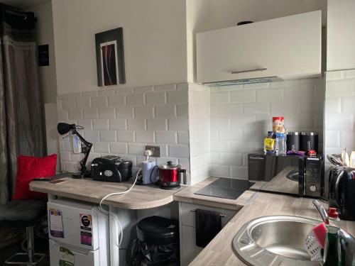 a kitchen with a sink and a counter top at Limpenny Garden Flat in Nottingham