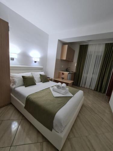 a bedroom with a large bed with a tray on it at Apartmani Matković in Sutomore