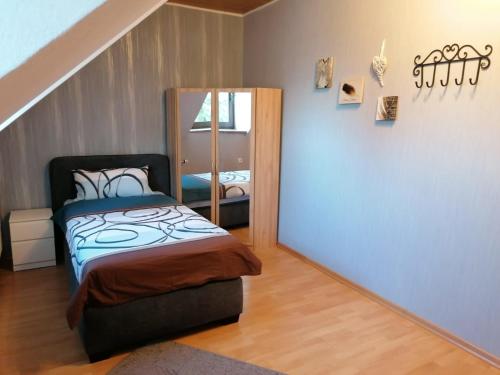 a bedroom with a bed and a mirror at Knoofs in Schwirzheim