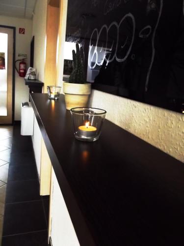a kitchen counter with a candle on it at Tündérszikla Panzió in Pilisjászfalu
