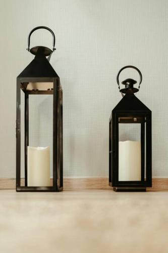 two black lanterns sitting on top of a table at La Villetta SPA -logement atypique in Mulhouse