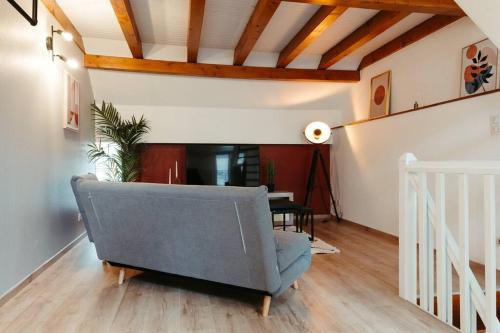 a living room with a couch and a table at La Villetta SPA -logement atypique in Mulhouse