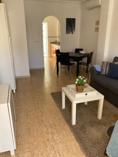 a living room with a couch and a table at Casa Vromans Alto in Torrevieja