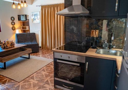 a kitchen with a sink and a stove top oven at MarGio Skiathos Apartments in Skiathos Town